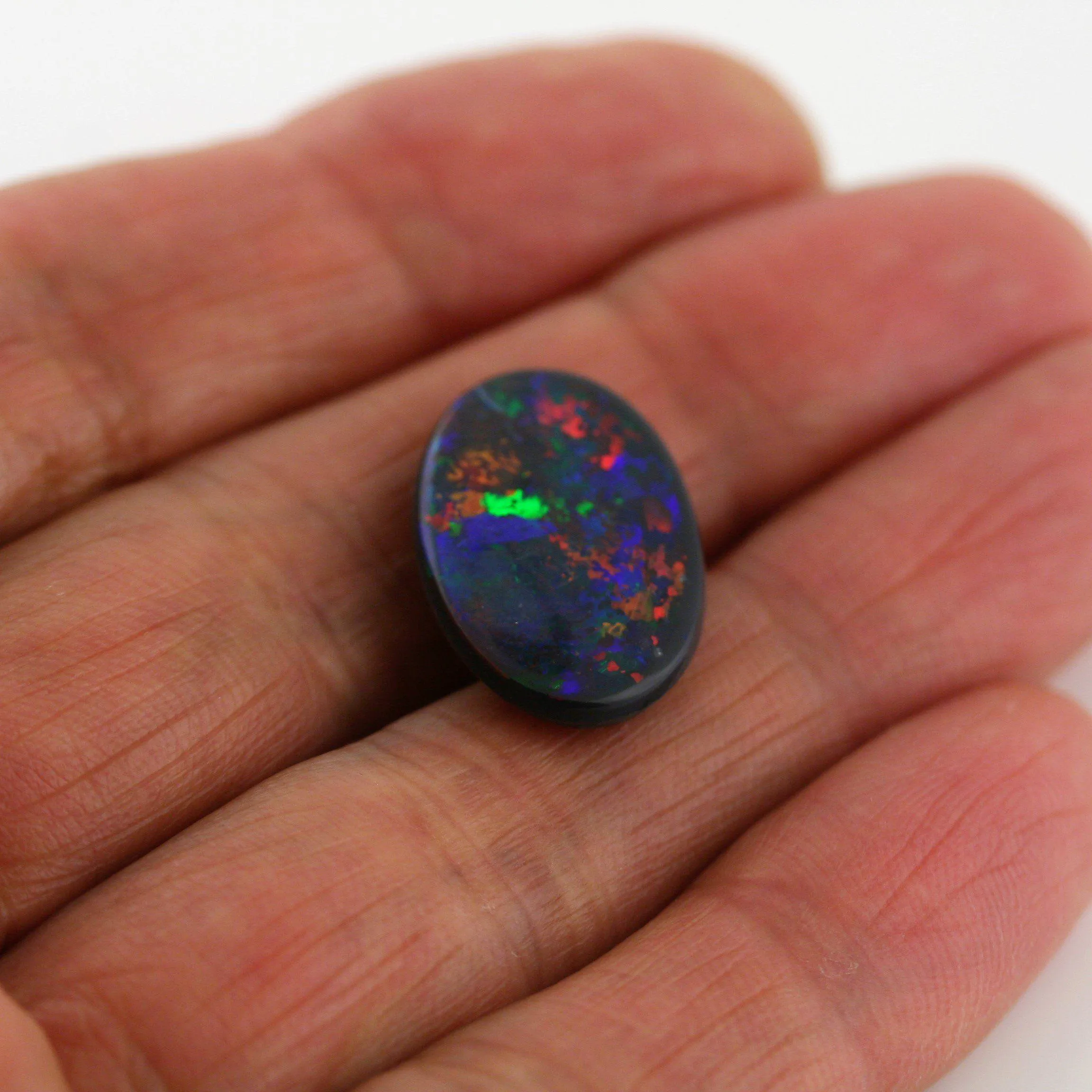 5.82 Carat Black Opal Cabochon Red Blue Green Orange Pin Fires