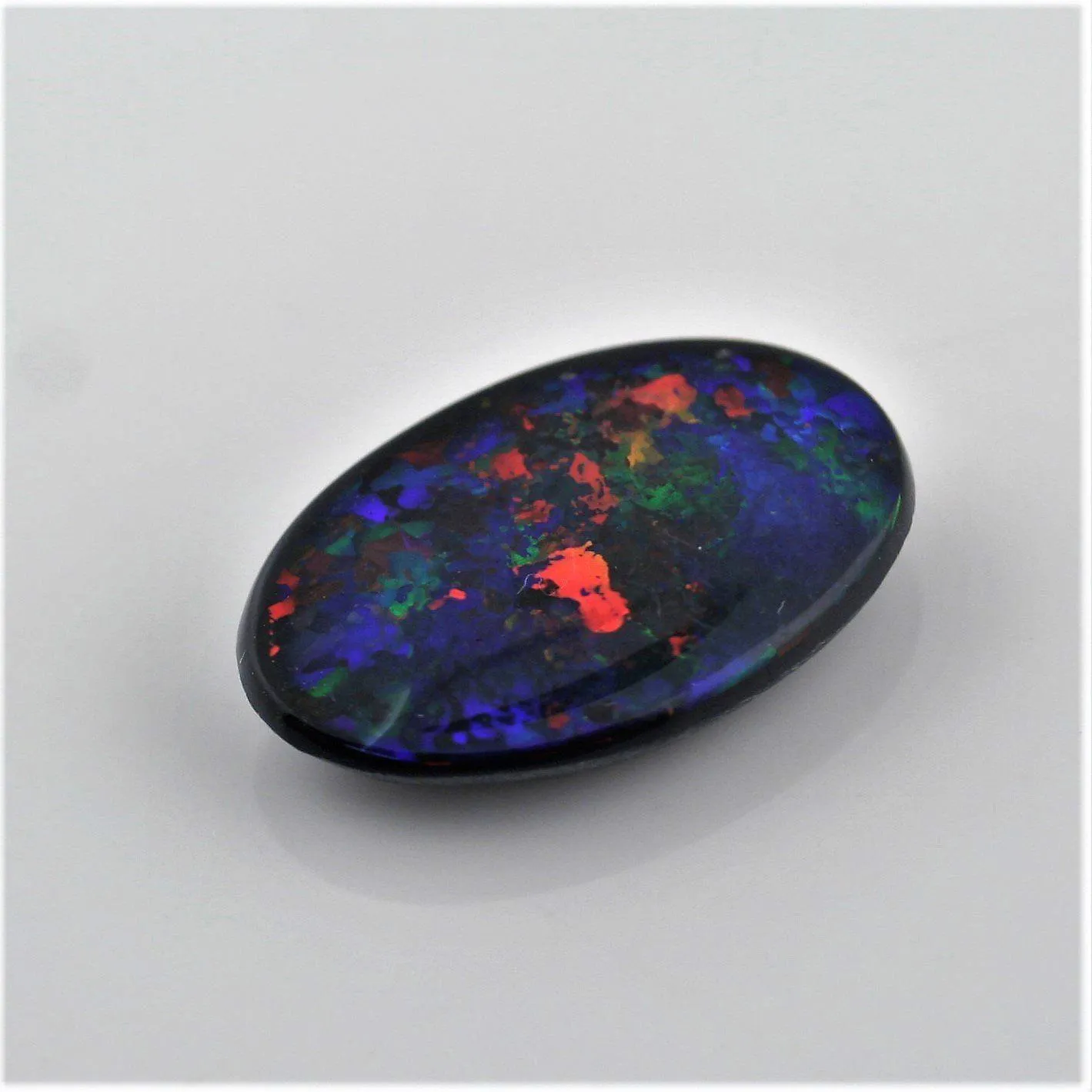 5.82 Carat Black Opal Cabochon Red Blue Green Orange Pin Fires