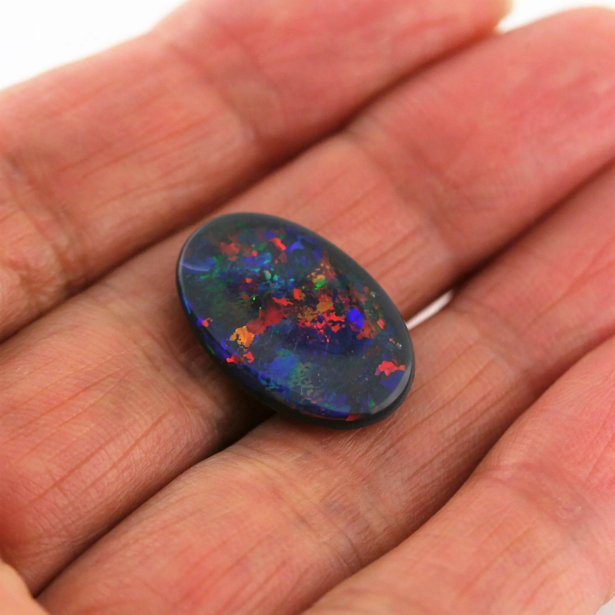 5.82 Carat Black Opal Cabochon Red Blue Green Orange Pin Fires