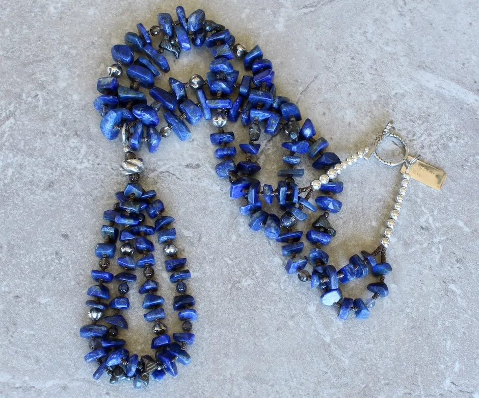 Lapis Lazuli Graduated Nugget 2-Strand Necklace with 2-Loop Lapis Jacla, Black Clay Bird Amulets, Blue Iolite and Smoky Quartz Rounds, Olive Shell Heishi, and Sterling Silver Rounds, Fluted Bicones, Coiled Rondelle Bead & Toggle Clasp