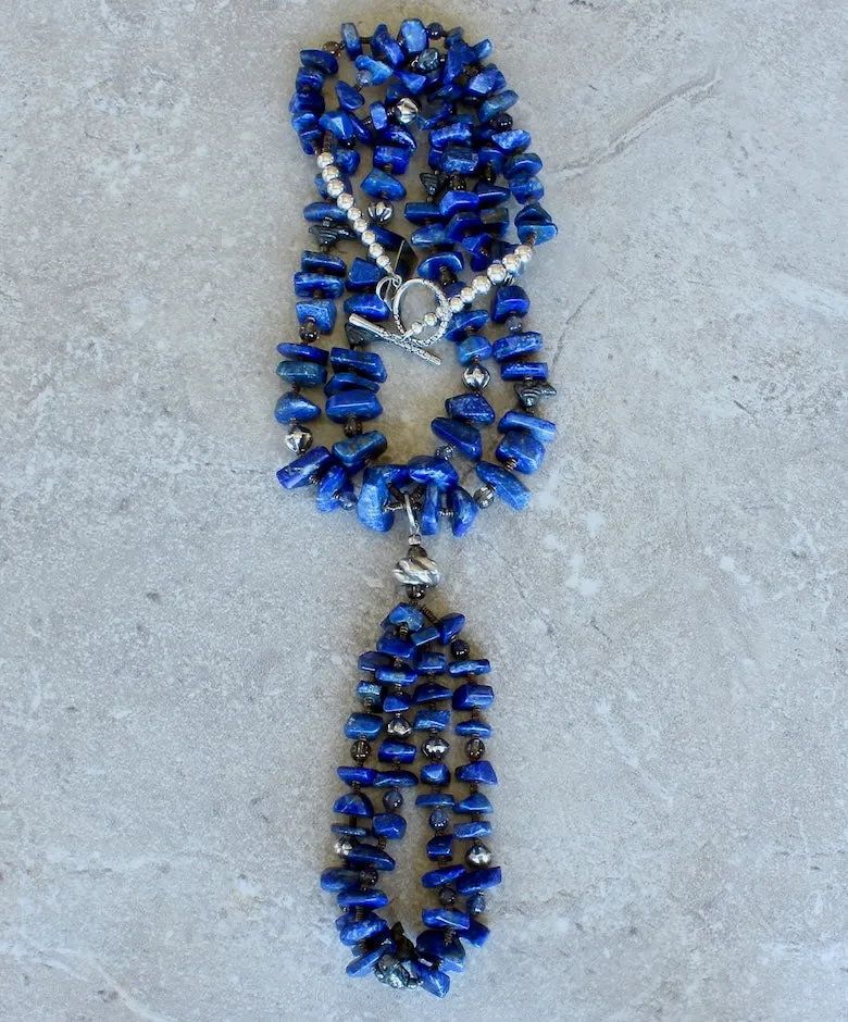 Lapis Lazuli Graduated Nugget 2-Strand Necklace with 2-Loop Lapis Jacla, Black Clay Bird Amulets, Blue Iolite and Smoky Quartz Rounds, Olive Shell Heishi, and Sterling Silver Rounds, Fluted Bicones, Coiled Rondelle Bead & Toggle Clasp